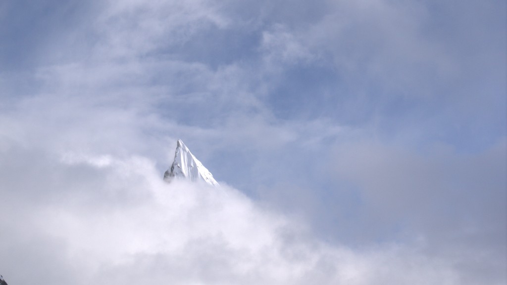 Summit of Laila Peak peaking through the clouds courtesy of Edward Blanchard Wrigglesworth